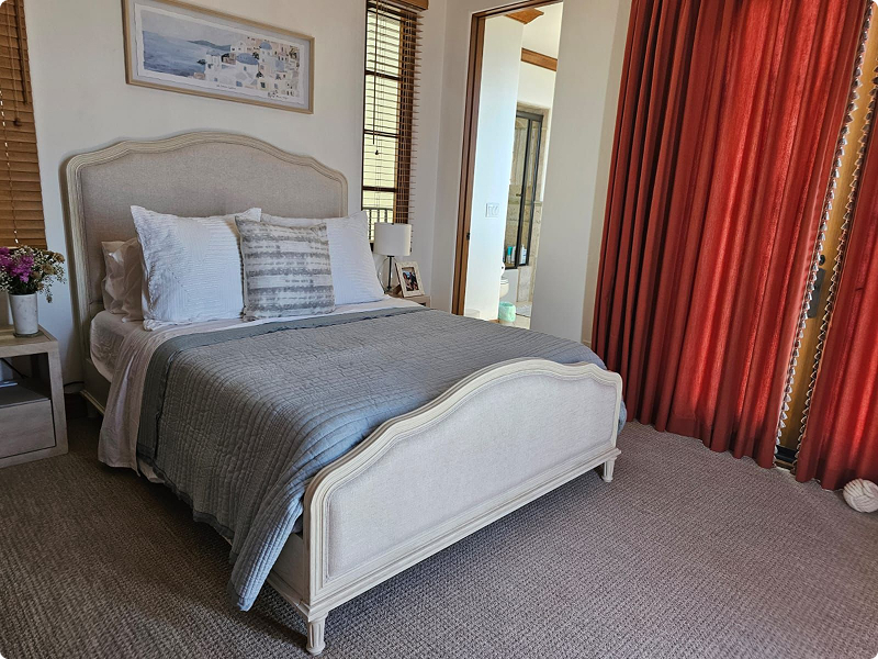 Neatly made bed in a tidy, freshly cleaned bedroom